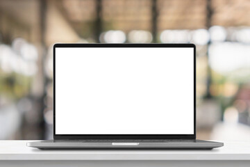 Laptop with blank screen on marble table with cafe coffee shop blur background