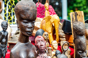 African tribal art for sale at a market stall.