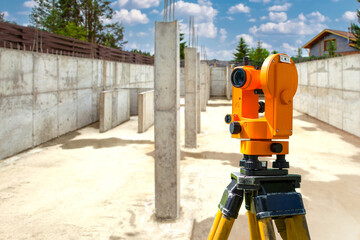Geodetic device. Optical geodetic equipment. Orange theodolite for surveyor. Construction equipment...