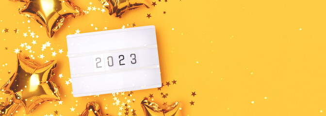 Banner with lightbox with 2023 numbers on a yellow background with place for text. Golden confetti...