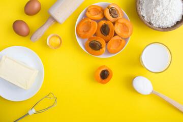 Top view of ingredients for making apricot pie or cake on the yellow background. Copy space.