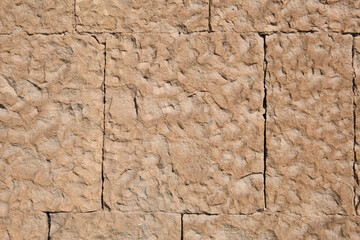 Masonry walls of natural sand color. Stone texture close-up, construction and mining background.