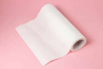 Paper towel on a pink background. Means for cleaning and hygiene. Disposable towel