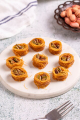 Bulbul Kadayif with Pistachio. Kadayif baklava with pistachio filling on a stone floor. Turkish cuisine desserts. Close-up. local name Antep Fıstıklı Bülbül Kadayıf