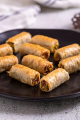 Pistachio baklava. Baklava filled with pistachio on a stone floor. Turkish cuisine desserts. close...