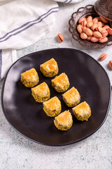 Pistachio baklava. Baklava filled with pistachio on a stone floor. Turkish cuisine desserts. close...
