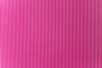 Abstract background made of corrugated paper for pink application. Space for text. Texture. Vertical stripes. © Cherkasova Alie