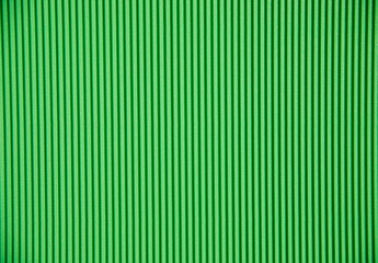 Abstract background made of corrugated paper for green application. Space for text. Texture. Vertical stripes.