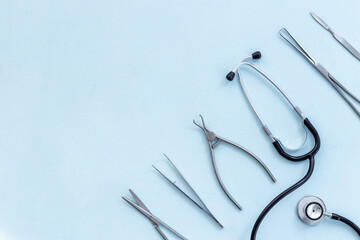 Dental or surgical steel instruments with stethoscope. Healthcare background