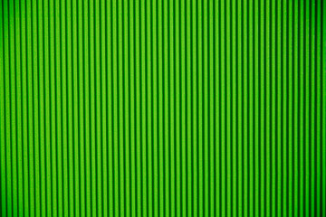 Abstract background made of corrugated paper for green application. Space for text. Texture. Vertical stripes.