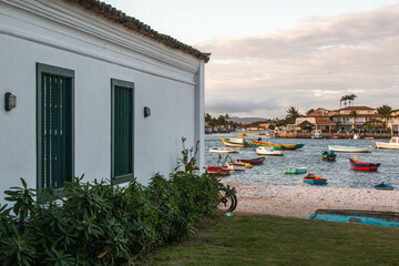 Typical colonial house next to the beach with small fishing boats, in the Passage neighborhood, Cabo Frio, Brazil.