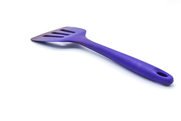 purple plastic kitchen spatula ideal for hamburger on white background