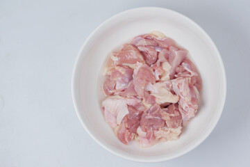 boneless slice of chicken meat in a bowl on white 