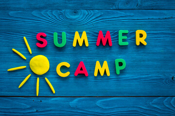 Camping concept. Color text Summer Camp with sun