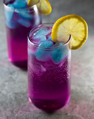 Bright refreshing cocktail. Pink lemonade with blue ice cubes. Galaxy lemonade. High quality photo