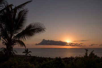 Obraz na płótnie Canvas Beautiful, tropical sunset at La Reunion, sun over the sea with orange sky