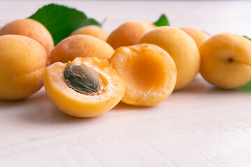 Apricots on white wooden background. Copy space