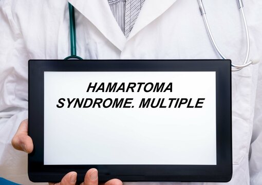 Hamartoma Syndrome.  Doctor with rare or orphan disease text on tablet screen Hamartoma Syndrome