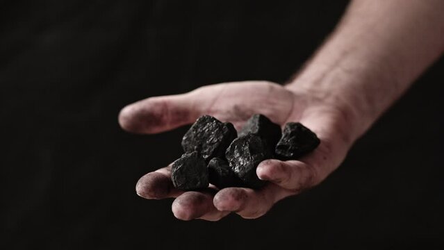 Coal in the hand of a miner.