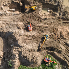 Aerial view of excavators on earthwork at construction site. Earthworks during the install of storm sewers. Sanitary sewer.