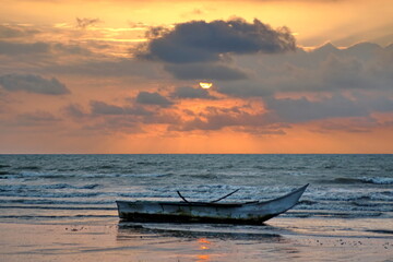 Fishing boat on the beach at sunset in Las Penas, Ecuador © Angela