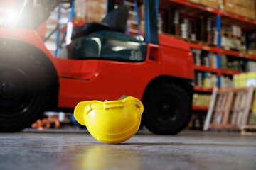 Safety hard hat helmet on floor in industrial warehouse factory. First Aid and safety first. Health...