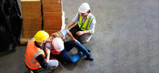 Top view. First Aid and safety first. Engineering talking on walki talki radio to employee while...
