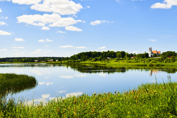 Aerial view Dambos lake pond panorama with St. Jacob the apostle church in Kurtuvenai town, with Lithuania countryside panorama background