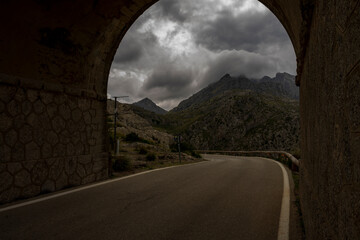 Krajobraz górski w szary pochmurny dzień. Tunel prowadzący do drogi Sa Calobra, Majorka...