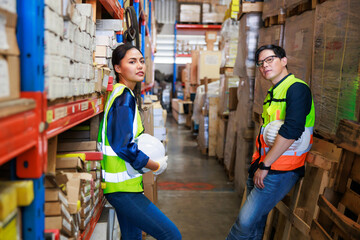 Portrait Asian male and female warehouse worker checking order stock. Professional industrial...
