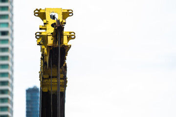 Yellow telescopic ​arms with hoist and sling of mobile construction crane.