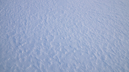 Texture of white snow with natural roughness.