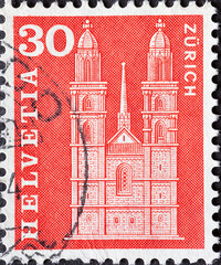 SWITZERLAND - CIRCA 1963: a postage stamp from Switzerland, showing the historic Swiss building the Grossmunster in Zurich . Circa 1963