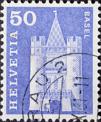 SWITZERLAND - CIRCA 1963: a postage stamp from Switzerland, showing the historic Swiss building the Spalen Gate, Basel. Circa 1963