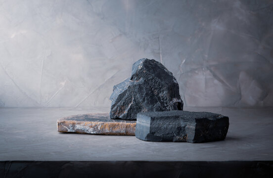 dark stone podium stage, stone composition for show product packaging and cosmetic on gray concrete wall background, copy space