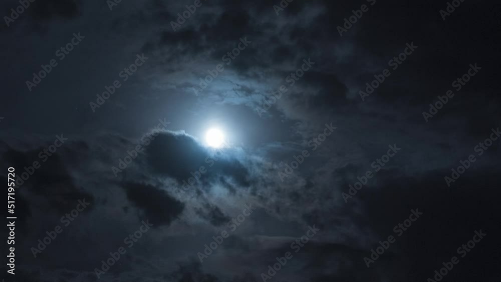Poster full moon at night with moving clouds. night timelapse with clouds and stars floating by