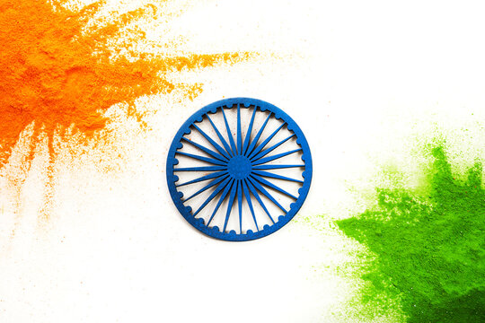 Orange and green color powder splash with Ashoka wheel. Concept for India independence day, 15th of august.