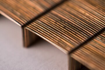 Closeup of thick bronze stapler pin texture