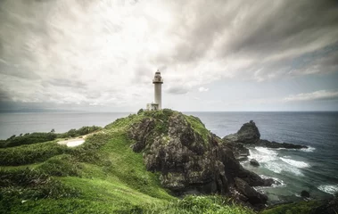 Foto auf Acrylglas Beautiful landscape of the lighthouse on a cloudy day in Oganzaki, Sakieda, Ishigaki, Okinawa, Japan © Nick Kwan/Wirestock Creators