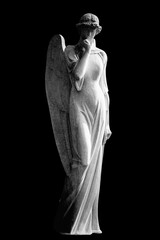 Black and white image of angel against dark background. Vertical image.