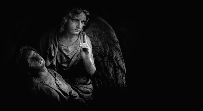 Black and white image of angel of death against dark background. Copy space for text.