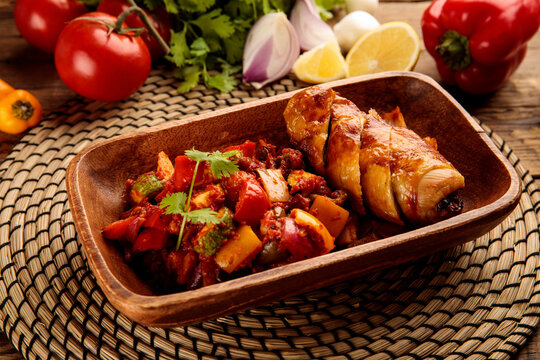 Stuffed Chicken Thigh Served In A Dish Isolated On Wooden Background Side View