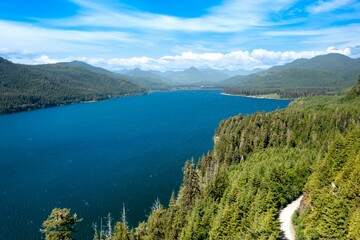 Aerial drone shot of the blue Nitinat Lake in Vancouver Island, BC, Canada © David Hutchison/Wirestock Creators