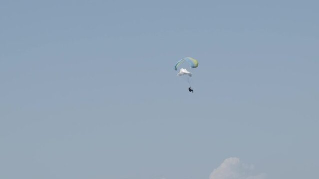 Paragliding accident. Paraglider spinning in the air while falling from the sky in a skydiving adventure.
