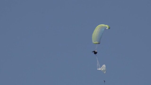 Paraglider opening the reserve parachute after a malfunction of the paragliding wing. Extreme skydiving.