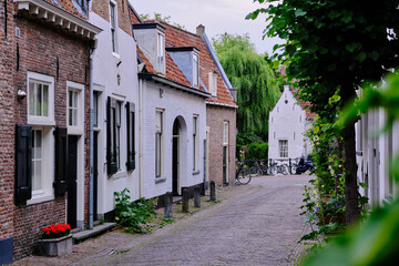 Fototapeta na wymiar Amersfoort, The Netherlands, July 6, 2022. Empty side streets with brick paving on a quiet summer’s evening. Selective focus.