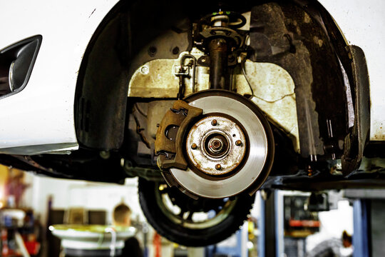 Disc brake of the vehicle for repair. Car on a lift.