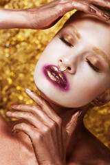 young woman with the shining smooth healthy skin of person brightly by the distinctly painted eyes...