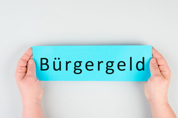 The german word for citizen money is standing on a paper, new financial help system for unemployment in Germany, social issue