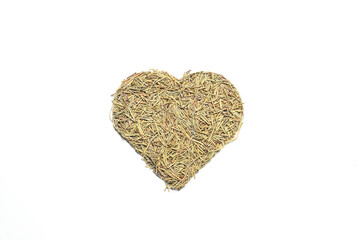 Heart shape rosemary herbs on a white background. Dried herbs, seasonings. Flat lay.
